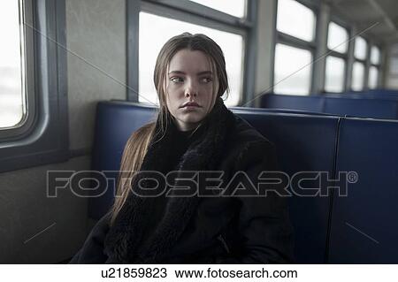 Young woman wearing black fur coat on train View Large Photo Image Stock Image - Young woman wearing black fur coat on train. Fotosearch