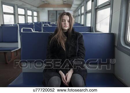 Young woman wearing black fur coat on train View Large Photo Image Stock Image - Young woman wearing black fur coat on train. Fotosearch