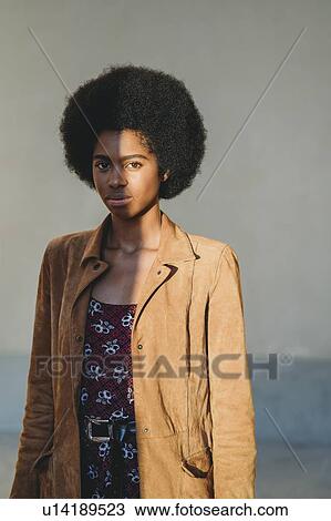 Young woman with afro hair in corridor View Large Photo Image Stock Image - Young woman with afro hair in corridor. Fotosearch