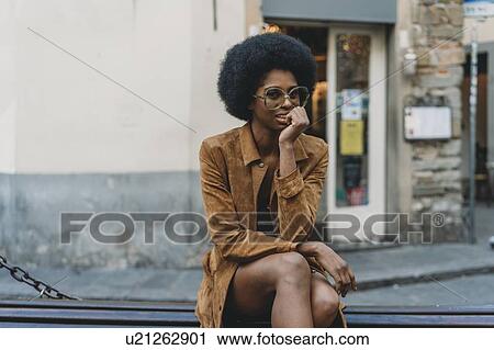Young woman with afro hair waiting in front of shop View Large Photo Image Stock Image - Young woman with afro hair waiting in front of shop. Fotosearch