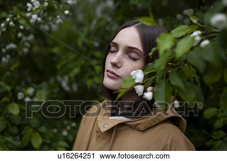 Young woman with her eyes closed by blossoms View Large Photo Image Stock Image - Young woman with her eyes closed by blossoms. Fotosearch