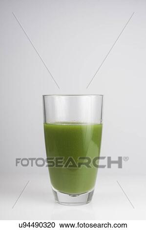 Stock Image - A glass of fresh green juice. Fotosearch