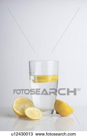 A glass of water with fresh lemon slices View Large Photo Image Stock Image - A glass of water with fresh lemon slices. Fotosearch
