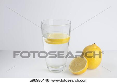 Stock Photograph - A glass of water with fresh lemon slices. Fotosearch