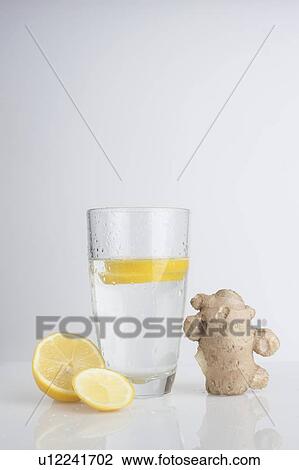 A glass of water with fresh lemon slices and ginger View Large Photo Image Stock Image - A glass of water with fresh lemon slices and ginger. Fotosearch