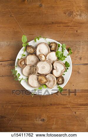 Stock Image - A plate of shiitake mushrooms (Lentinula edodes). Fotosearch