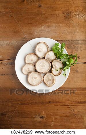 Stock Photo - A plate of shiitake mushrooms (Lentinula edodes). Fotosearch