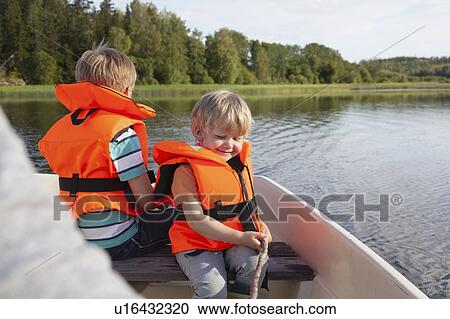 Adult sailing with boys on boat in lake, Finland View Large Photo Image Stock Image - Adult sailing with boys on boat in lake, Finland. Fotosearch