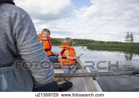 Adult sailing with boys on boat in lake, Finland View Large Photo Image Stock Photo - Adult sailing with boys on boat in lake, Finland. Fotosearch