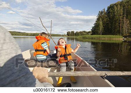 Adult sailing with excited boys on boat in lake, Finland View Large Photo Image Stock Image - Adult sailing with excited boys on boat in lake, Finland. Fotosearch