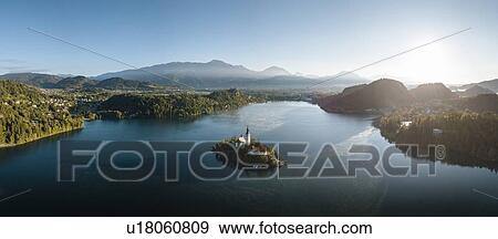 Aerial view of Bled Island with Church of the Assumption at dawn, Lake Bled, Upper Carniola, Slovenia View Large Photo Image Stock Photo - Aerial view of Bled Island with Church of the Assumption at dawn, Lake Bled, Upper Carniola, Slovenia. Fotosearch