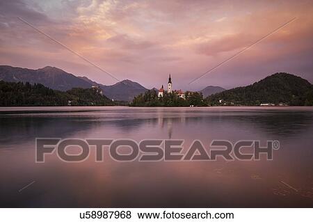 Aerial view of Bled Island with Church of the Assumption at dusk, Lake Bled, Upper Carniola, Slovenia View Large Photo Image Stock Photo - Aerial view of Bled Island with Church of the Assumption at dusk, Lake Bled, Upper Carniola, Slovenia. Fotosearch