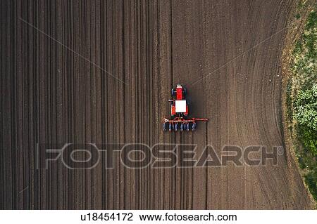 Aerial view of tractor sowing corn in field View Large Photo Image Stock Image - Aerial view of tractor sowing corn in field. Fotosearch