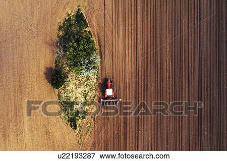 Aerial view of tractor with seeder View Large Photo Image Stock Photo - Aerial view of tractor with seeder. Fotosearch
