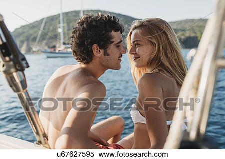 Stock Photography - Affectionate couple on sailboat, Italy. Fotosearch
