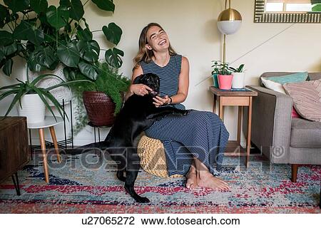 Affectionate dog on woman's lap View Large Photo Image Stock Image - Affectionate dog on woman's lap. Fotosearch