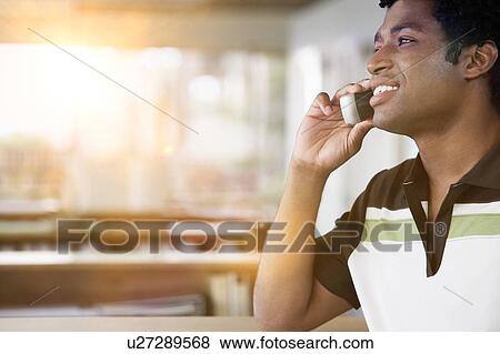 African American Man using mobile phone in office View Large Photo Image Stock Photo - African American Man using mobile phone in office. Fotosearch