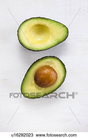 An avocado cut in half View Large Photo Image Stock Image - An avocado cut in half. Fotosearch