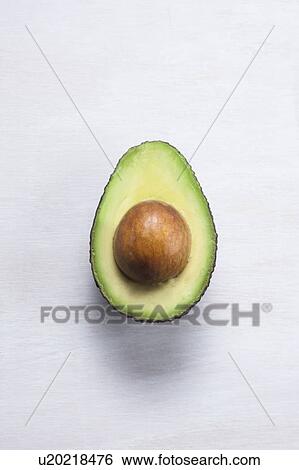 An avocado cut in half View Large Photo Image Stock Photograph - An avocado cut in half. Fotosearch
