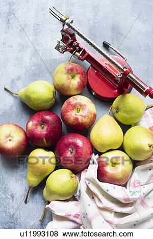 Apple peeler with apples and pears on table View Large Photo Image Stock Photo - Apple peeler with apples and pears on table. Fotosearch