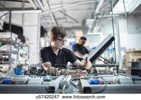 Apprentice electronics engineers in electronics assembly factory View Large Photo Image Stock Photo - Apprentice electronics engineers in electronics assembly factory. Fotosearch