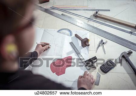 Apprentice engineer with tools and plans in steelworks View Large Photo Image Stock Photo - Apprentice engineer with tools and plans in steelworks. Fotosearch