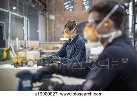 Apprentice working on wooden mould in steelworks View Large Photo Image Stock Photo - Apprentice working on wooden mould in steelworks. Fotosearch
