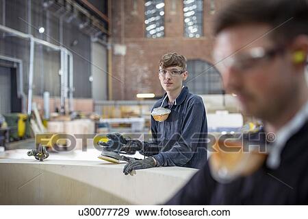 Apprentice working on wooden mould in steelworks View Large Photo Image Stock Photo - Apprentice working on wooden mould in steelworks. Fotosearch