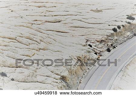 Arid winding desert motorway highway View Large Photo Image Stock Photo - Arid winding desert motorway highway. Fotosearch