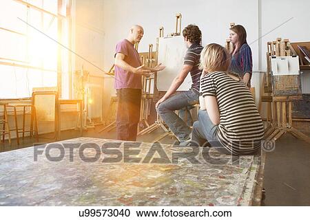 Artist talking to young artists in studio View Large Photo Image Stock Image - Artist talking to young artists in studio. Fotosearch