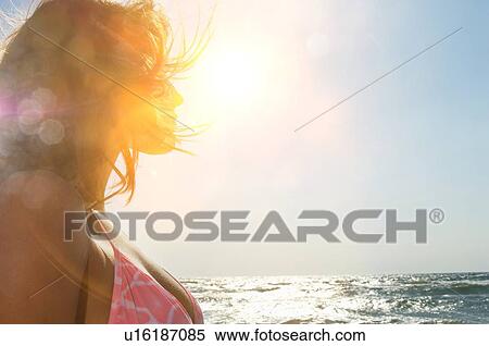 Attractive woman in bikini staring and sunshine View Large Photo Image Stock Photography - Attractive woman in bikini staring and sunshine. Fotosearch