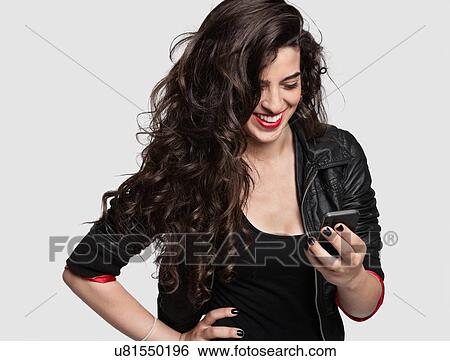 Stock Photograph - Attractive woman using cell phone. Fotosearch