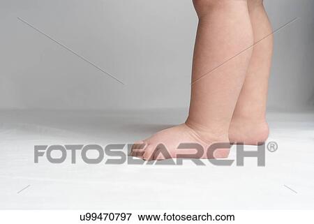 Stock Photo - Baby (6-12 months) standing low section. Fotosearch