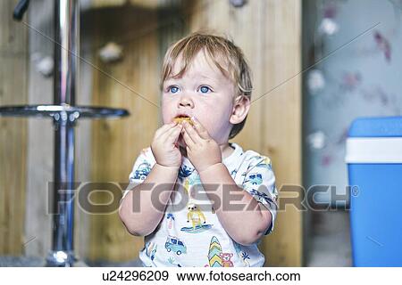 Baby girl eating biscuit with both hands View Large Photo Image Stock Photo - Baby girl eating biscuit with both hands. Fotosearch