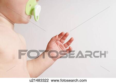 Baby with pacifier mid section View Large Photo Image Stock Image - Baby with pacifier mid section. Fotosearch