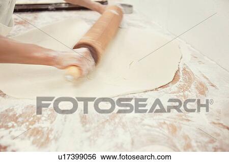 Baker's hands rolling bread in kitchen View Large Photo Image Stock Photograph - Baker's hands rolling bread in kitchen. Fotosearch