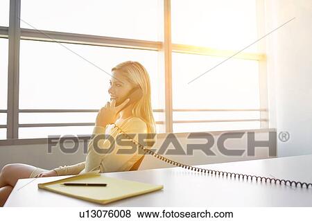 Stock Photo - Beautiful blonde woman from home. Fotosearch