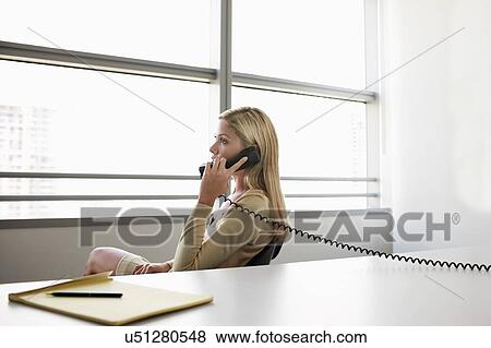 Stock Photo - Beautiful blonde woman from home. Fotosearch