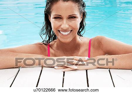 Stock Photograph - Beautiful brunette Woman in Swimming Pool. Fotosearch