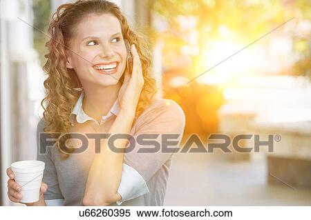 Beautiful woman drinking coffee at and using cell phone outdoors View Large Photo Image Stock Photography - Beautiful woman drinking coffee at and using cell phone outdoors. Fotosearch