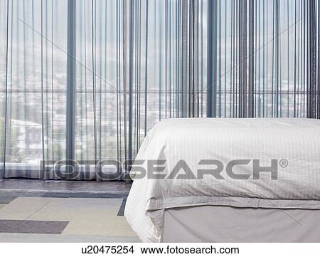 Bed and curtains in bedroom View Large Photo Image Picture - Bed and curtains in bedroom. Fotosearch