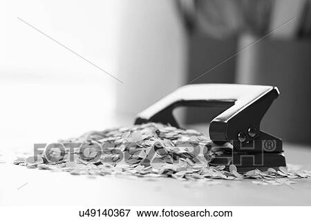 Black and white photo of hole punch and paper bits View Large Photo Image Stock Photo - Black and white photo of hole punch and paper bits. Fotosearch