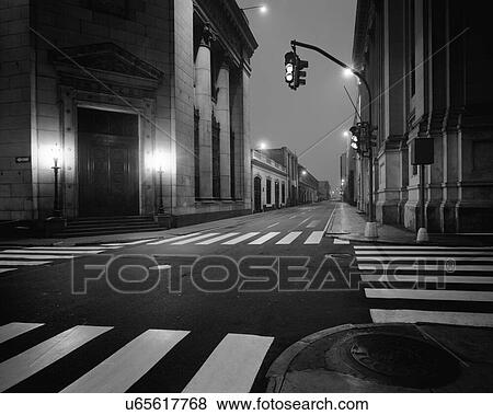 Stock Photo - Black and white photo of traffic lights in an empty street and road. Fotosearch