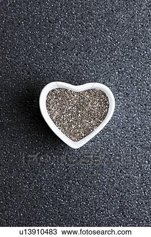 Black chia seeds in heart shaped dish View Large Photo Image Stock Image - Black chia seeds in heart shaped dish. Fotosearch