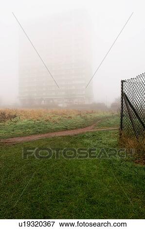 Stock Photo - Block of flats hidden behind fog. Fotosearch
