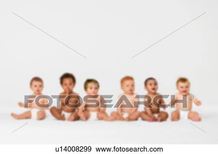 Stock Photo - Blurred photo of Row of six multi ethnic Babies smiling in studio. Fotosearch