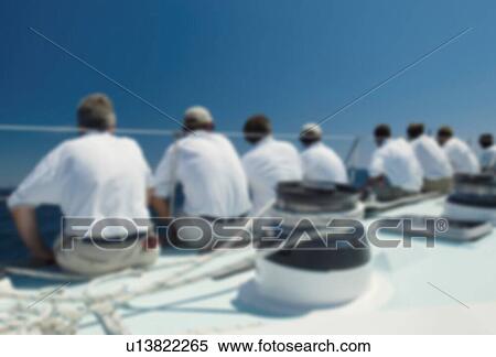 Blurred Rear view of sailing crew sitting on boat View Large Photo Image Stock Photography - Blurred Rear view of sailing crew sitting on boat. Fotosearch