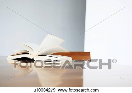 Stock Photo - Book open at a page on table. Fotosearch