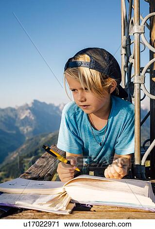 Boy enjoying view and writing notes on peak, Bludenz, Vorarlberg, Austria View Large Photo Image Stock Image - Boy enjoying view and writing notes on peak, Bludenz, Vorarlberg, Austria. Fotosearch