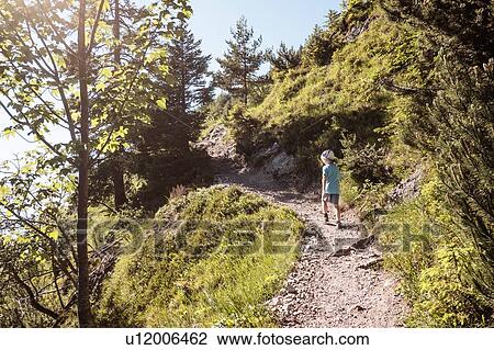Stock Image - Boy hiking on trail, Bludenz, Vorarlberg, Austria. Fotosearch